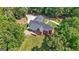 Aerial view of the property with a brick exterior, deck, and lush green lawn at 1000 Turner Church Rd, Mcdonough, GA 30252