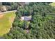 Aerial view of the property showcasing mature trees and a lush green lawn at 1000 Turner Church Rd, Mcdonough, GA 30252