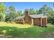 Brick home featuring a spacious backyard with a wooden deck, perfect for outdoor entertaining at 1000 Turner Church Rd, Mcdonough, GA 30252