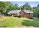 Well-maintained brick home with a spacious backyard and a large wooden deck at 1000 Turner Church Rd, Mcdonough, GA 30252