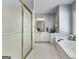 Clean bathroom showcasing a shower, bathtub, single sink vanity, and tiled floors at 1000 Turner Church Rd, Mcdonough, GA 30252