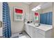 Bright bathroom featuring a single sink vanity with blue accents and natural light from a window at 1000 Turner Church Rd, Mcdonough, GA 30252