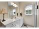 Bathroom with white vanity, sink, and window, and a glass-door shower at 1000 Turner Church Rd, Mcdonough, GA 30252