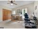 Bedroom featuring bunkbed, ceiling fan, and desk, with natural light from two windows at 1000 Turner Church Rd, Mcdonough, GA 30252