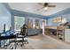 Blue-themed bedroom featuring a desk area, lofted bed, and carpet flooring at 1000 Turner Church Rd, Mcdonough, GA 30252