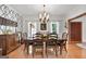 Dining room features hardwood floors, large windows, crown molding, and wallpaper accent at 1000 Turner Church Rd, Mcdonough, GA 30252