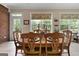 Dining area with table set for six, natural light, and backyard view at 1000 Turner Church Rd, Mcdonough, GA 30252