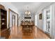 Formal dining room with hardwood floors, crown molding, and elegant chandelier at 1000 Turner Church Rd, Mcdonough, GA 30252