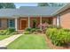 Charming brick home with a covered front porch and beautiful landscaping at 1000 Turner Church Rd, Mcdonough, GA 30252