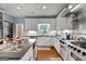 Bright, updated kitchen with stainless appliances and a view to dining room at 1000 Turner Church Rd, Mcdonough, GA 30252