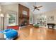 Inviting living room features a brick fireplace and hardwood floors at 1000 Turner Church Rd, Mcdonough, GA 30252
