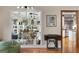 Bright living room showcasing built-in shelving with plants and a view of the kitchen at 1000 Turner Church Rd, Mcdonough, GA 30252