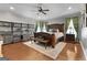 Spacious main bedroom featuring a wooden bed frame, hardwood floors, and decorative curtains at 1000 Turner Church Rd, Mcdonough, GA 30252