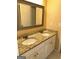 Bathroom featuring a double vanity with granite countertops and decorative mirror at 3381 Walkers Ridge Rd, Dacula, GA 30019