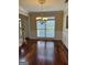 Sunlit dining area features wood floors, a classic chandelier, and wainscoting detail at 3381 Walkers Ridge Rd, Dacula, GA 30019