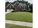 Traditional brick two-story home with a well-manicured lawn and attached two-car garage at 3381 Walkers Ridge Rd, Dacula, GA 30019