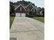 Brick two-story home features a two-car garage and well-maintained front lawn at 3381 Walkers Ridge Rd, Dacula, GA 30019