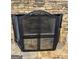 Stone fireplace with mesh screen and tools adds charm to the living space at 3381 Walkers Ridge Rd, Dacula, GA 30019