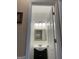 Half bath features a dark vanity, decorative mirror, and modern lighting fixture at 3381 Walkers Ridge Rd, Dacula, GA 30019