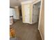 Hallway featuring carpeted floors and neutral paint, with multiple access doors at 3381 Walkers Ridge Rd, Dacula, GA 30019