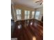 Bright living room with gleaming hardwood floors, a ceiling fan, and plantation shutters at 3381 Walkers Ridge Rd, Dacula, GA 30019