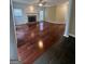 Spacious living room with a stone fireplace, hardwood floors, and bright windows at 3381 Walkers Ridge Rd, Dacula, GA 30019