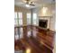 Inviting living room with hardwood flooring, a stone fireplace, and ample natural light at 3381 Walkers Ridge Rd, Dacula, GA 30019