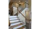 Elegant staircase with hardwood and carpeted steps, complemented by white spindles at 3381 Walkers Ridge Rd, Dacula, GA 30019