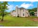 Exterior shot of the backyard with vinyl siding and a view of the manicured lawn at 907 Brisley Cir, Hampton, GA 30228