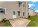 View of the backyard featuring a cement patio, vinyl siding, and well manicured grass at 907 Brisley Cir, Hampton, GA 30228