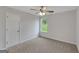 Bedroom with a ceiling fan, a window, neutral carpet and a door at 907 Brisley Cir, Hampton, GA 30228
