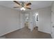 Bedroom with carpet, a ceiling fan and entrance to a bathroom at 907 Brisley Cir, Hampton, GA 30228