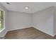 Empty room with new vinyl flooring and a large window at 907 Brisley Cir, Hampton, GA 30228