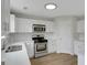 Well-lit kitchen featuring stainless steel appliances and white countertops at 907 Brisley Cir, Hampton, GA 30228