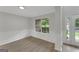 Bright, empty living room with new vinyl flooring and a large window at 907 Brisley Cir, Hampton, GA 30228