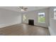 Bright living room featuring hardwood floors, a fireplace, and dual windows at 907 Brisley Cir, Hampton, GA 30228