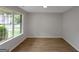 Bright, empty living room with new vinyl flooring and a large window at 907 Brisley Cir, Hampton, GA 30228