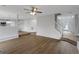 Bright living room featuring hardwood floors, ceiling fan and an open staircase to the front door at 907 Brisley Cir, Hampton, GA 30228