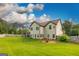 Wide-open backyard featuring a lush lawn, trees and partial fencing at 150 Bellemeade Ct, Fayetteville, GA 30215