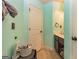 Bathroom featuring mint green walls, a white door, and a dark vanity offering a fresh and clean design at 150 Bellemeade Ct, Fayetteville, GA 30215