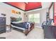 Bedroom with decorative trey ceiling, black furniture, and natural light from a window with closed blinds at 150 Bellemeade Ct, Fayetteville, GA 30215