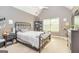 Neutral-toned bedroom with carpet, a dark metal bed frame and a window offering a serene and relaxing atmosphere at 150 Bellemeade Ct, Fayetteville, GA 30215