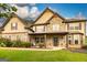 Beautiful two-story home featuring a stone facade, inviting front porch, and well-manicured lawn at 150 Bellemeade Ct, Fayetteville, GA 30215