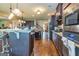 Well-equipped kitchen with dark wood cabinets, stainless appliances, and center island with breakfast bar at 150 Bellemeade Ct, Fayetteville, GA 30215