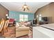 Living room with hardwood floors, blue accent wall, and a tan leather couch, offering a cozy space at 150 Bellemeade Ct, Fayetteville, GA 30215
