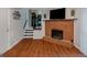 Cozy basement with hardwood floors, a brick fireplace, and access to the upper level at 3823 Rock Hollow Ct, Conley, GA 30288