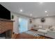 Basement area featuring a brick fireplace, a gray sofa, and hardwood floors at 3823 Rock Hollow Ct, Conley, GA 30288
