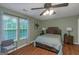 This bright bedroom features hardwood floors and a large window that lets in plenty of natural light at 3823 Rock Hollow Ct, Conley, GA 30288