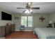 Bright bedroom with hardwood flooring, ceiling fan, and a large window for lots of natural light at 3823 Rock Hollow Ct, Conley, GA 30288