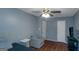 Cozy bedroom features a ceiling fan, chair, and hardwood floors for a comfy and stylish retreat at 3823 Rock Hollow Ct, Conley, GA 30288